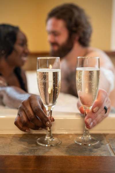 Couple buvant du champagne dans la baignoire. 