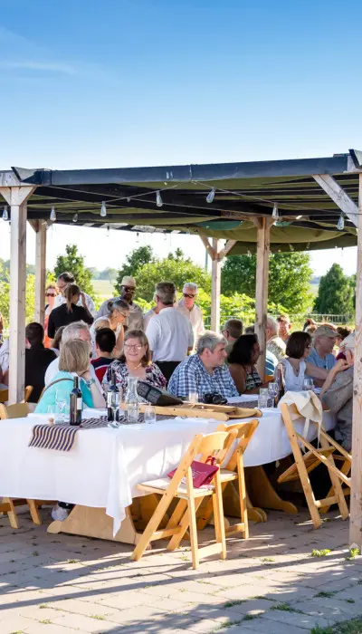 Les gens se réunissent autour de tables et socialisent.