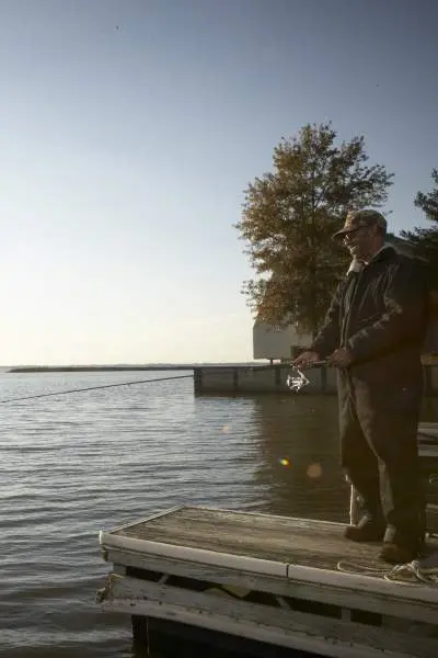 Pêcheur au lever du soleil au lac Rend.