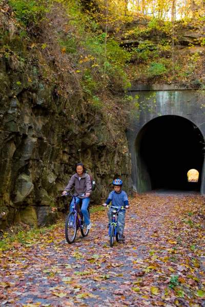 Deux personnes traversant un tunnel à vélo 