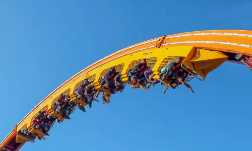 Groupe de personnes sur les montagnes russes en plein vol. 