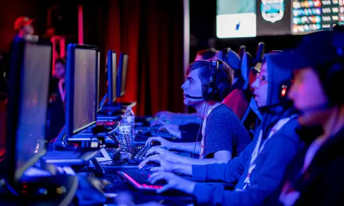 Personnes sur ordinateur participant à un tournoi esports